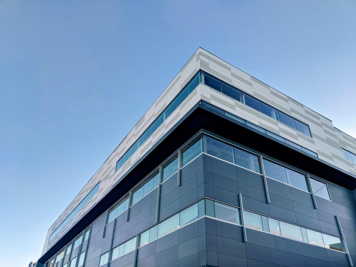 Modern angular office block against a blue sky